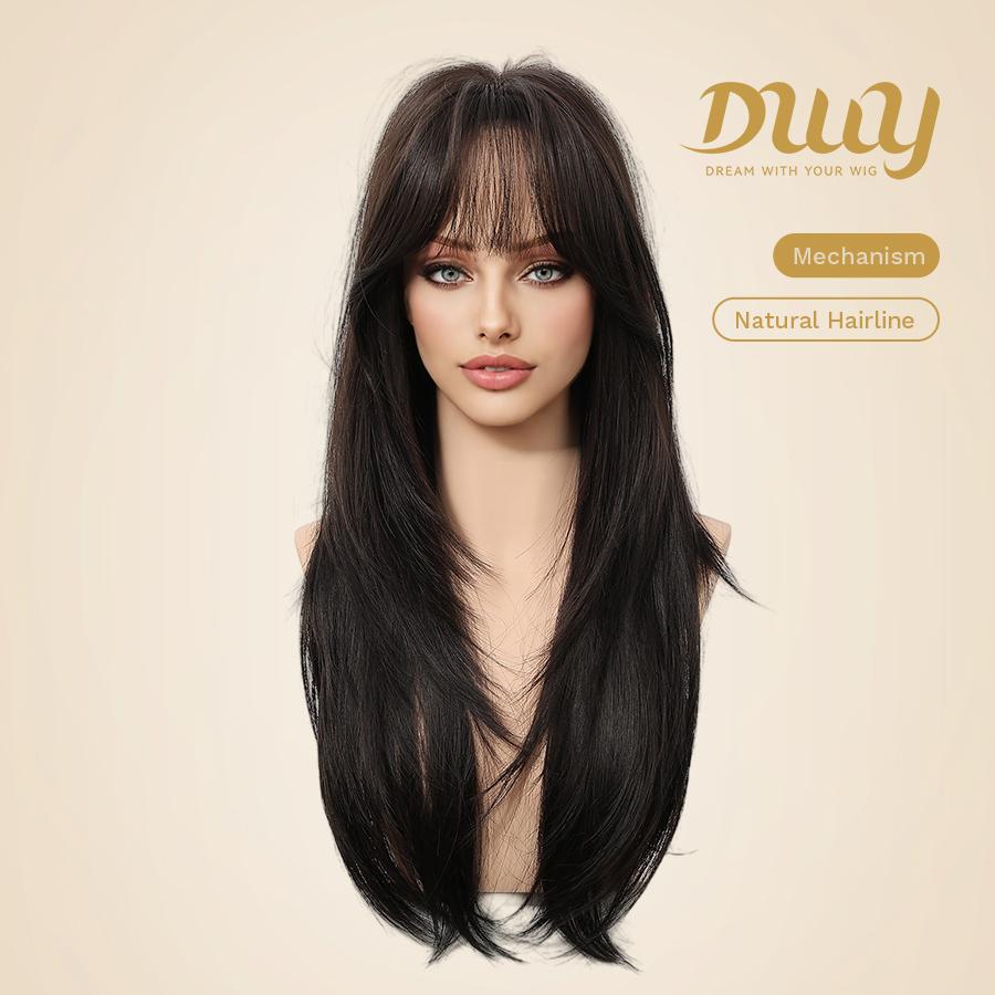 A product photograph of a realistic female mannequin head displaying a long, layered dark brown wig with wispy bangs. The mannequin has full makeup with prominent blue eyes. The wig is styled with face-framing layers and is centered in the frame against a plain beige studio background. In the upper right corner, there is gold branding text 