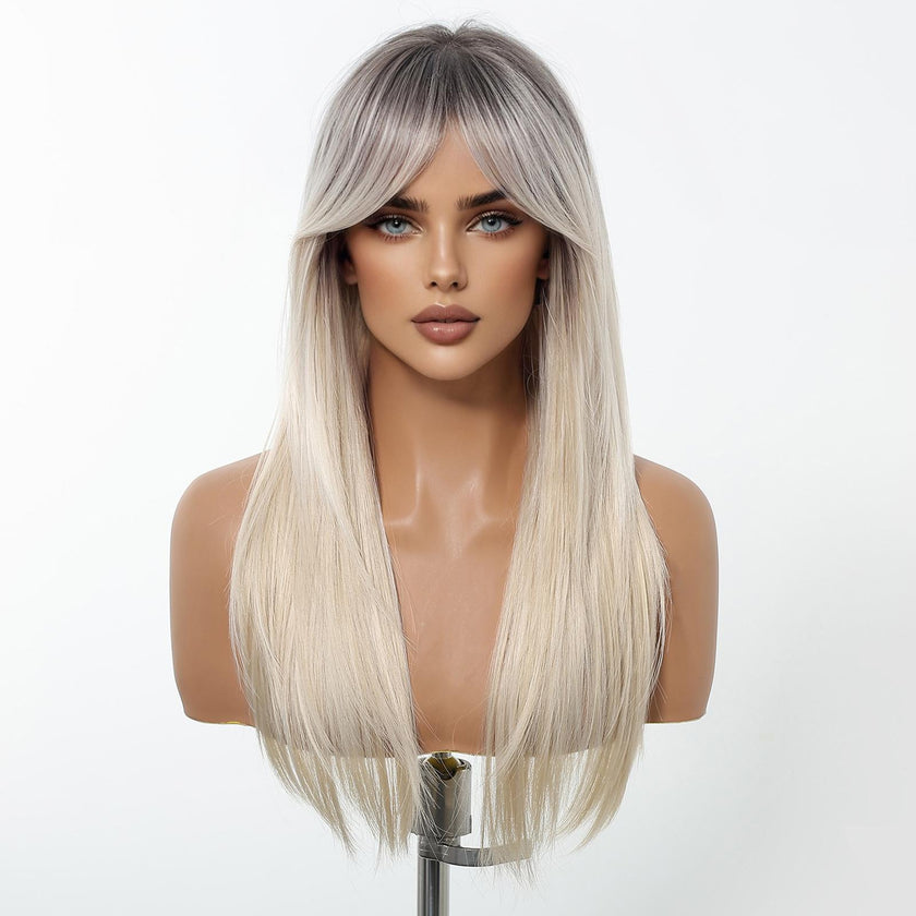 A female mannequin head displays a long, straight DWY wig featuring a trendy root-smudge effect, transitioning from dark roots to a bright platinum blonde. The wig includes full, sweeping curtain bangs.