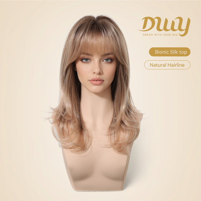 Woman wearing a shoulder-length blonde balayage wig with soft layered ends and natural bangs, featuring a realistic bionic silk top and natural hairline design for a seamless everyday look.