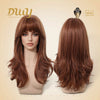 A front and back view of a mannequin head displaying a long, layered auburn-brown DWY wig with full bangs and voluminous curls, set against a beige background with the brand logo and Muse Design Awards badge.