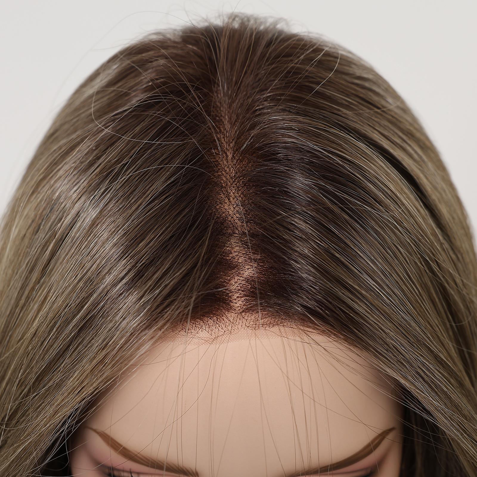 A detailed top-down close-up of a DWY wig, showing the realistic, hand-tied lace front and a defined central monofilament part. The dark brown roots seamlessly blend into a highlighted ash-blonde balayage. The fine, individual hair strands are clearly visible at the ultra-fine hairline against the skin-like scalp.