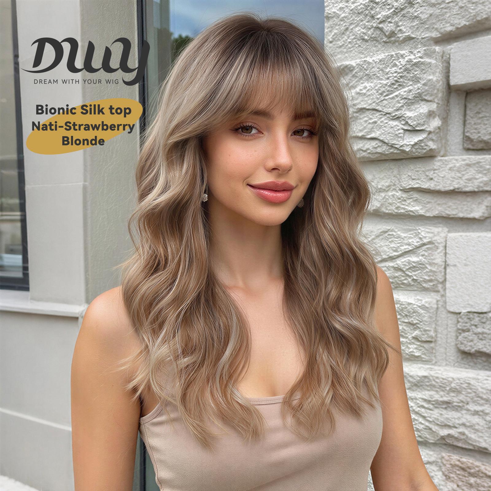 A photo of a smiling young woman wearing a long, wavy, strawberry-blonde DWY wig with full bangs. Text overlay on the beige background highlights 