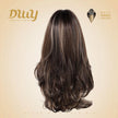 Back view of a mannequin head showcasing the DWY long layered synthetic wig in brown and blonde highlights, set against a beige studio backdrop with a logo badge.