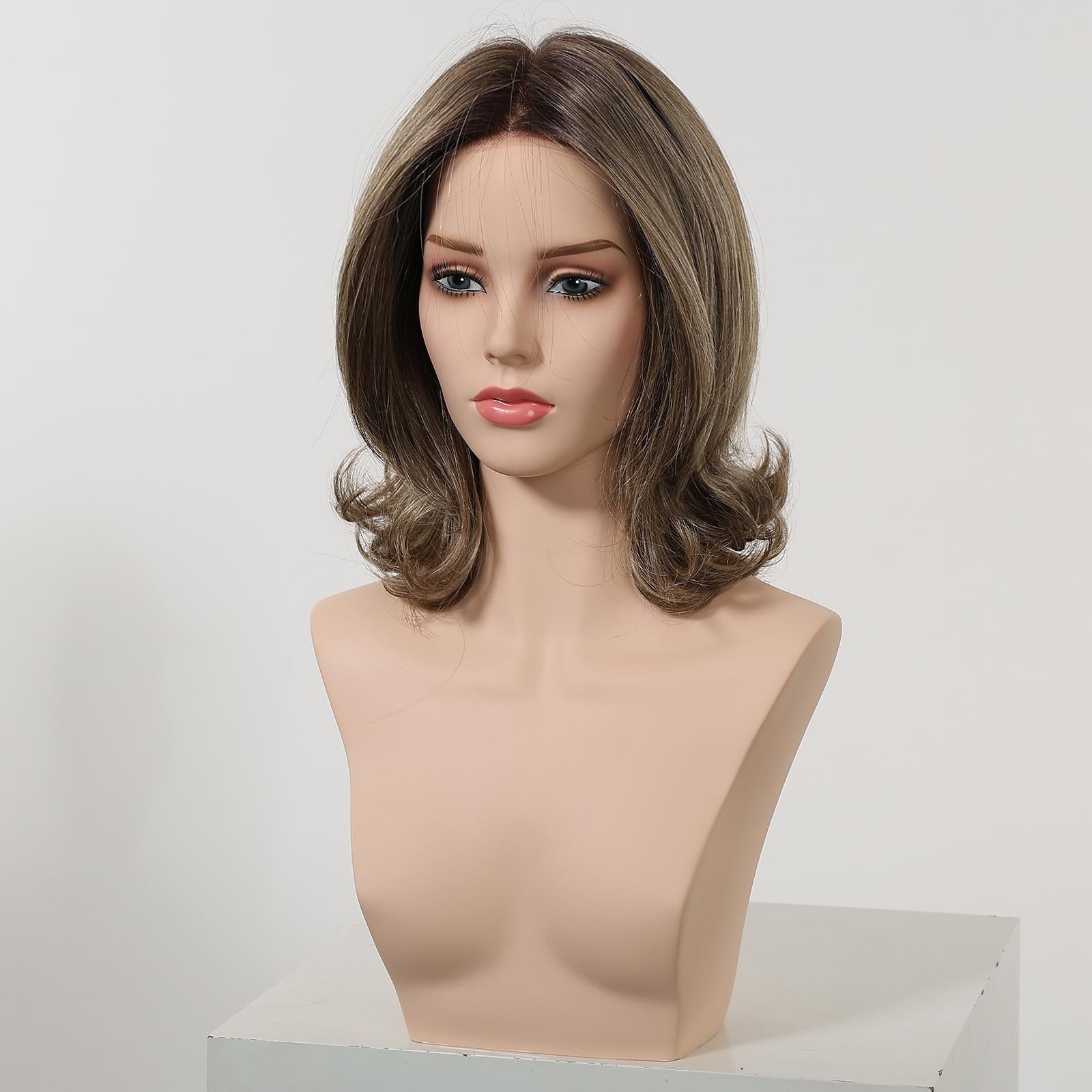 A medium-length DWY wig displayed on a female mannequin head against a plain white studio background. The layered hair features a dark ash brown root and transitions to a lighter ash brown towards the ends, styled with a center part and curled, flipped ends.