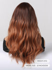 A back view of a realistic mannequin head displaying a long, wavy DWY wig with a dark brown to copper red ombre color gradient, set against a clean white background with product information text.