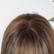 Close-up view of a mixed dark blonde bob wig showing a realistic scalp area, natural-looking hair roots, and a seamless parting design for a more lifelike and elegant wig appearance.