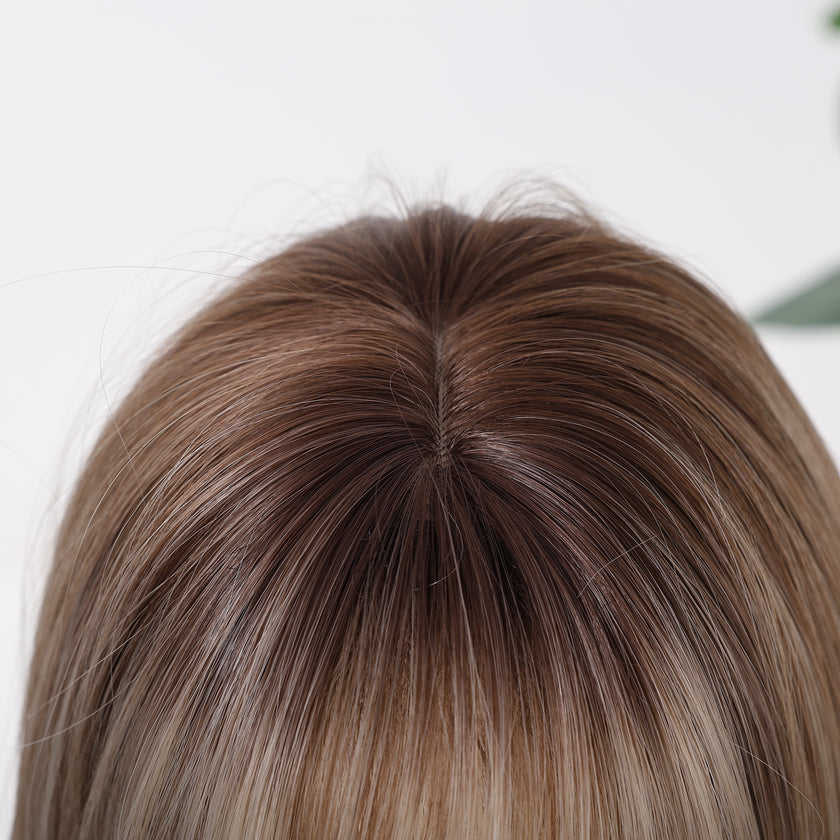 Close-up view of a mixed dark blonde bob wig showing a realistic scalp area, natural-looking hair roots, and a seamless parting design for a more lifelike and elegant wig appearance.