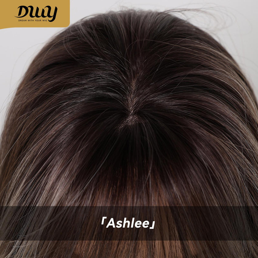 A detailed close-up of the parting line and roots on a DWY synthetic wig, showing multi-tonal brown hair with a realistic scalp effect and straight fringe.