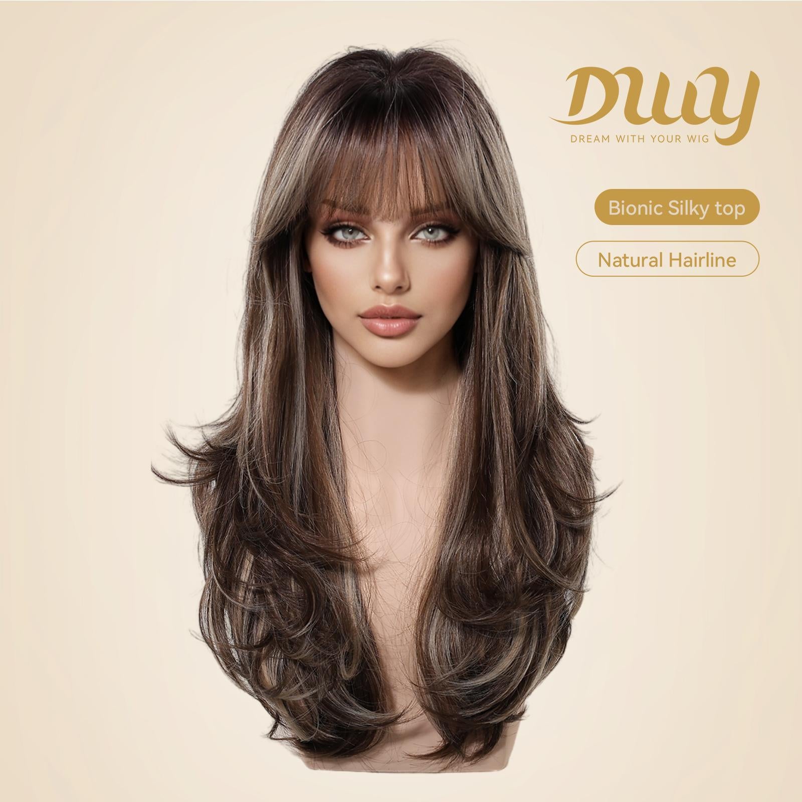 A female mannequin head displays the DWY long layered synthetic wig with bangs in brown and blonde highlights, featuring a 'Bionic Silky top' on a beige background.